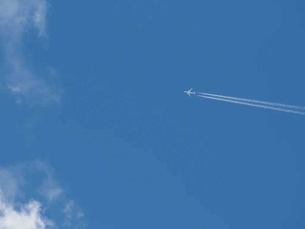 a jet in a mostly-clear sky