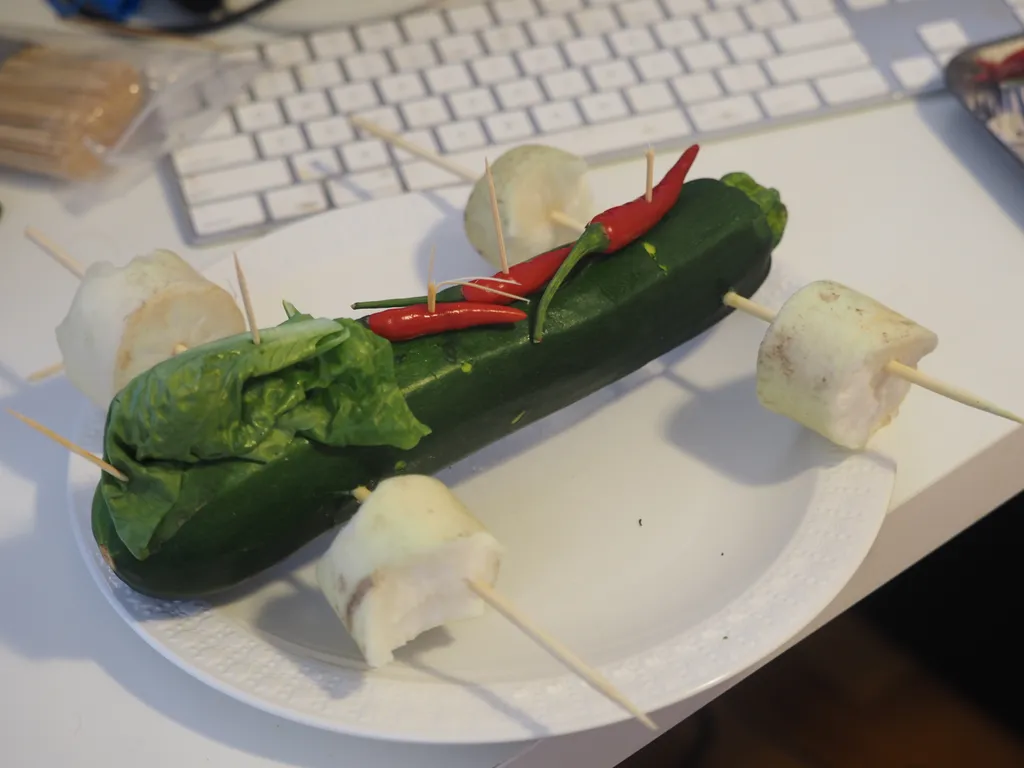 a pinewood derby car made out of vegetables and wooden skewers