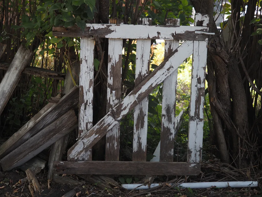 a wooden gate with peeling paint