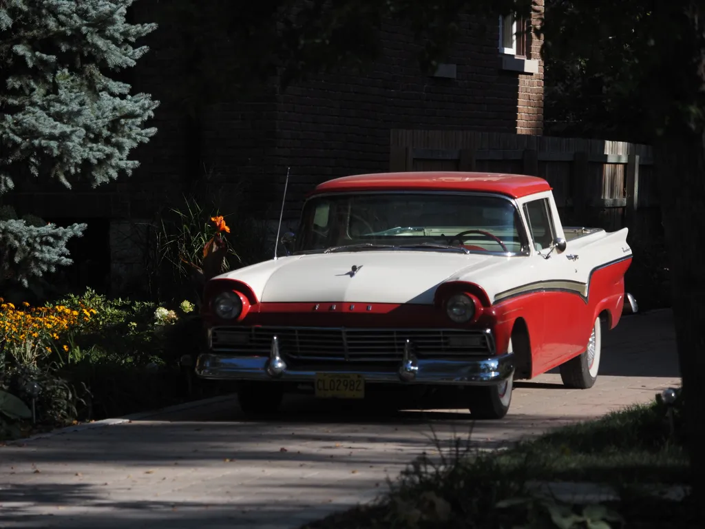 a red and white classic ford pickup truck