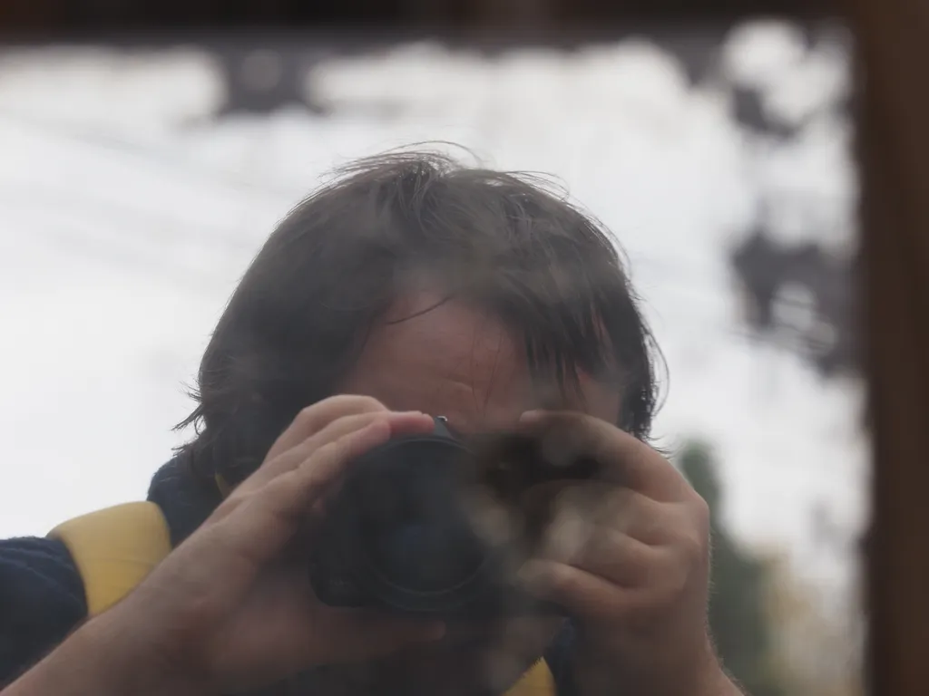 a selfie taken in a mirror with its silvering peeling