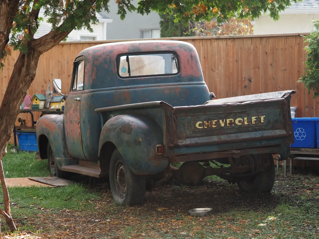 an antique chevy pickup covered in rust