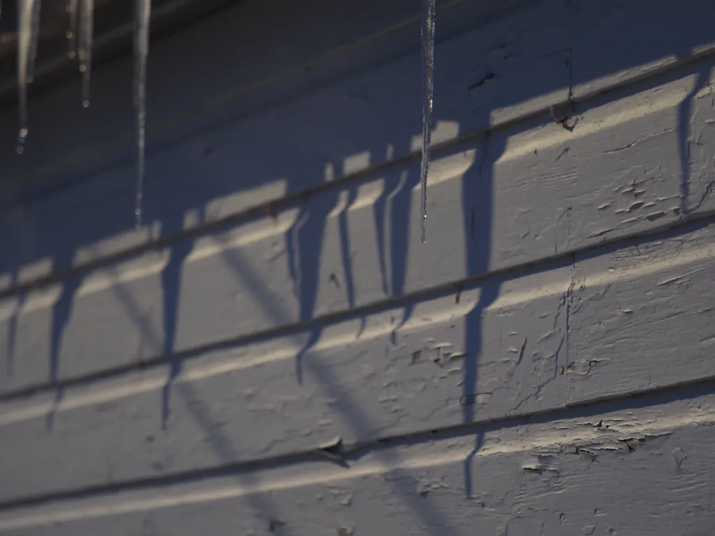 icicles casting shadows on a wall