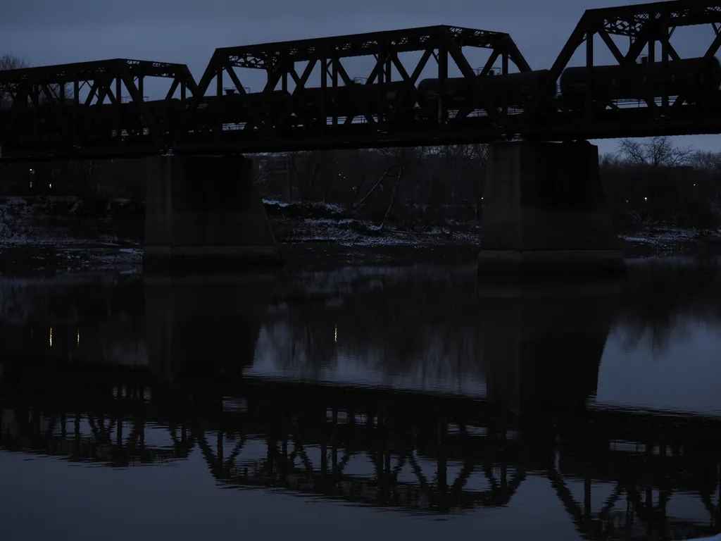 a train crossing a river at night