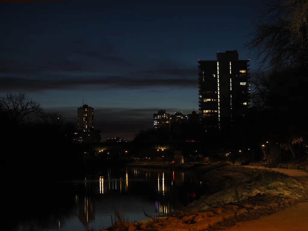 buildings reflecting in a river at night