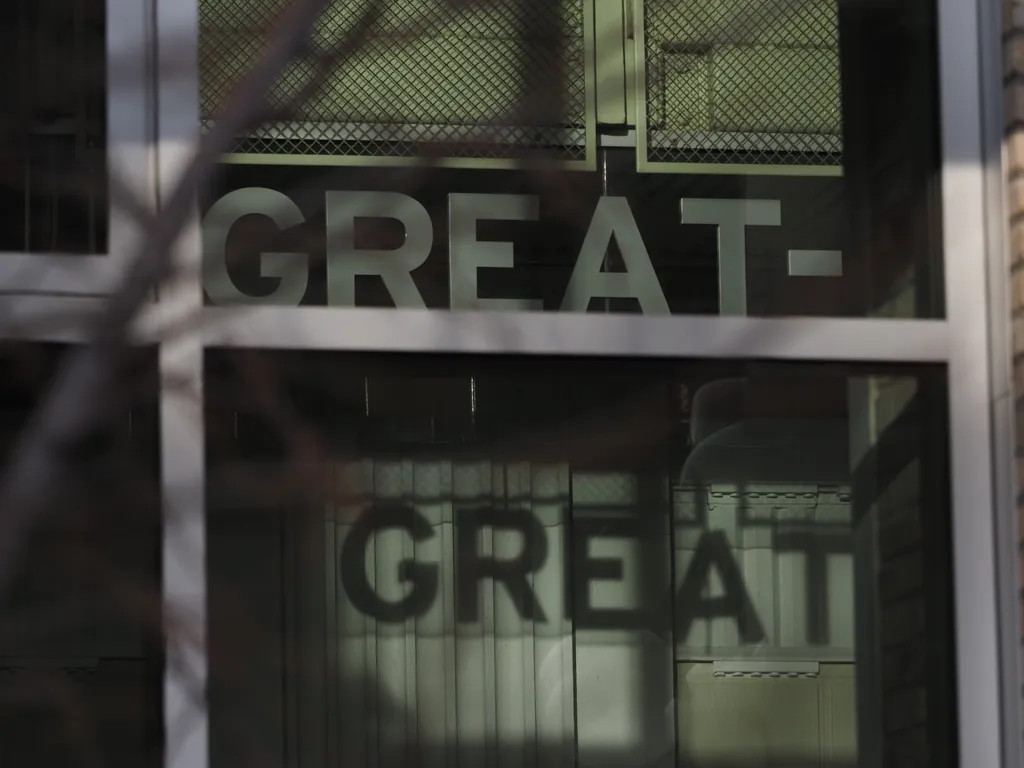 the word 'great' cast as a shadow on a wall