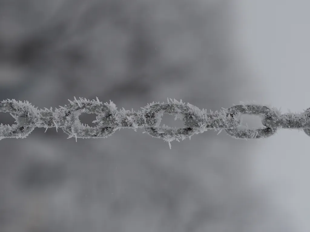 frost on the chain of a swingset