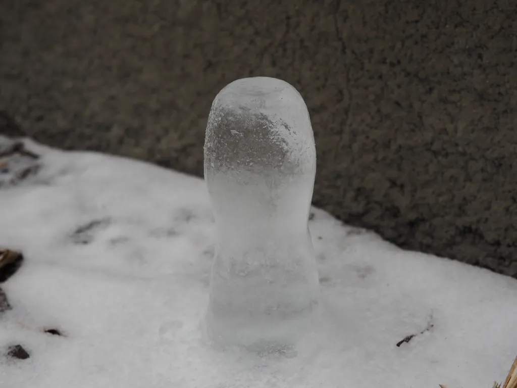 a large ice stalagmite formed under a pipe