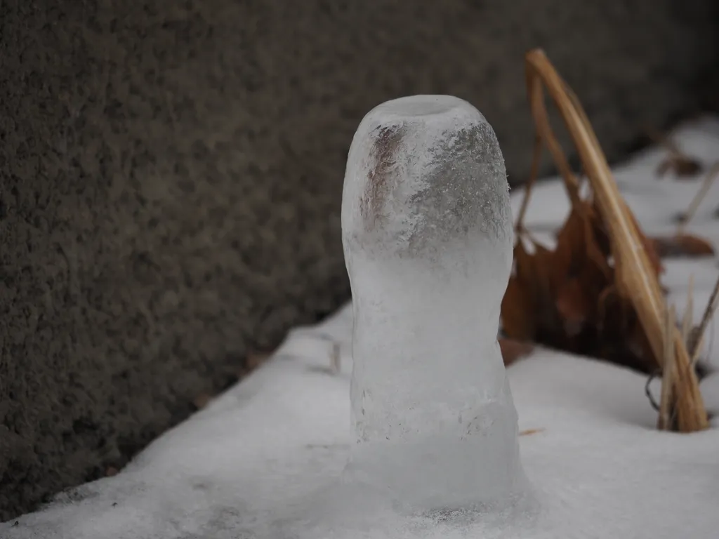 a large ice stalagmite formed under a pipe