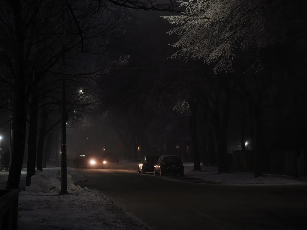 a car on a foggy street at night