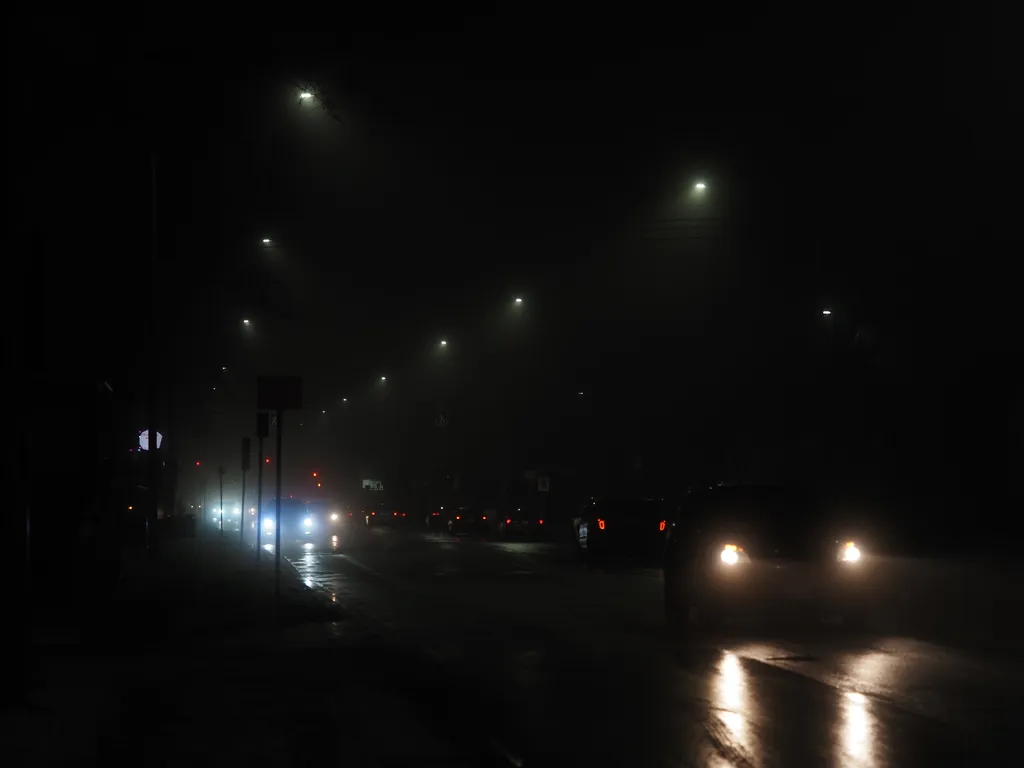 a busy street on a foggy night