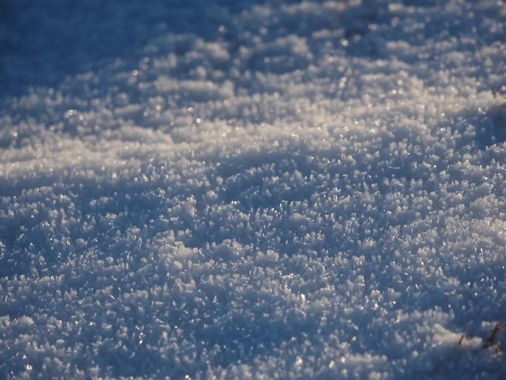 ice crystals formed on top of a thin layer of snow