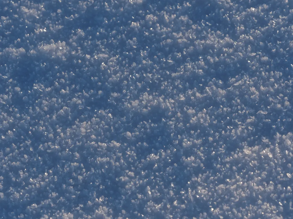 ice crystals formed on top of a thin layer of snow