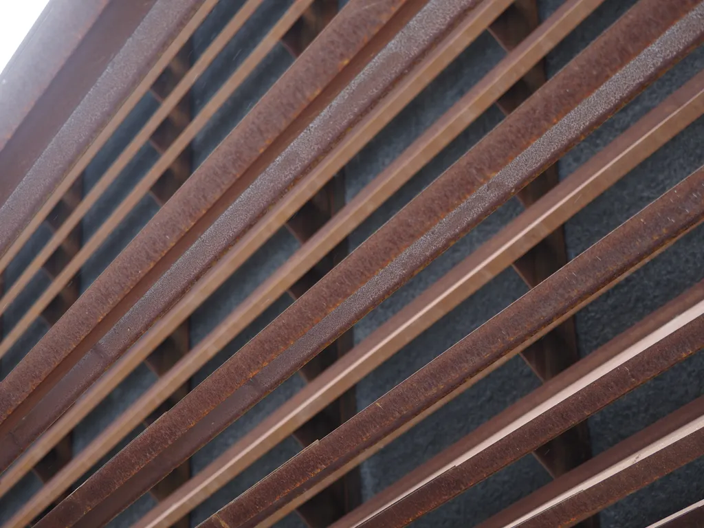 rusty metal slats on the side of a building