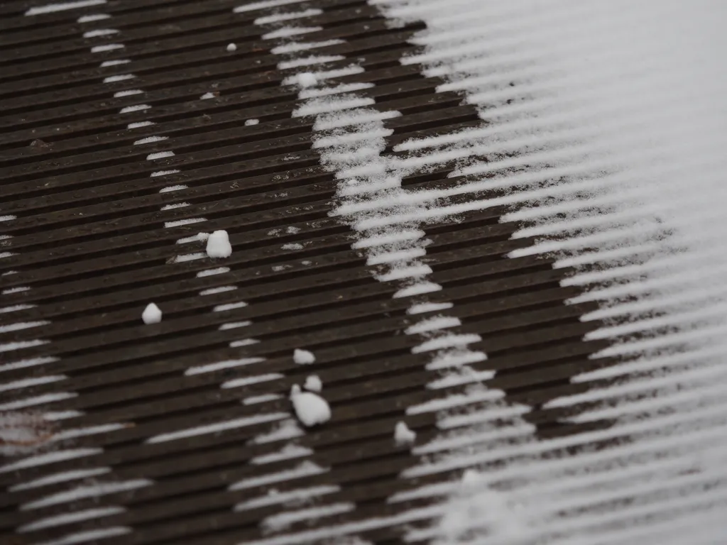 snow on a metal grating