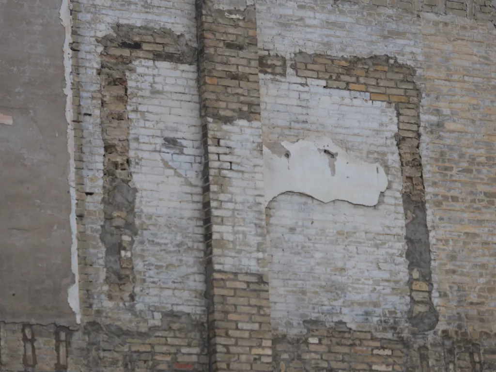 the marks of a now-removed wall on the outside brick wall of a building