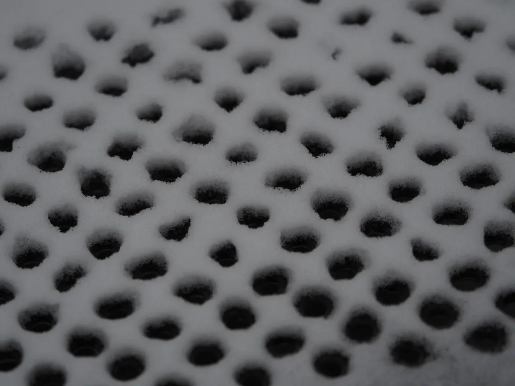 snow on a metal grating of a play structure