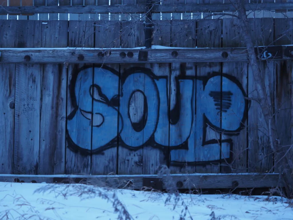 the word 'soup' written in large letters on the side of a wooden walkway