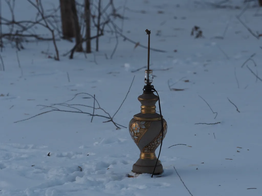 a lamp sitting in the snow