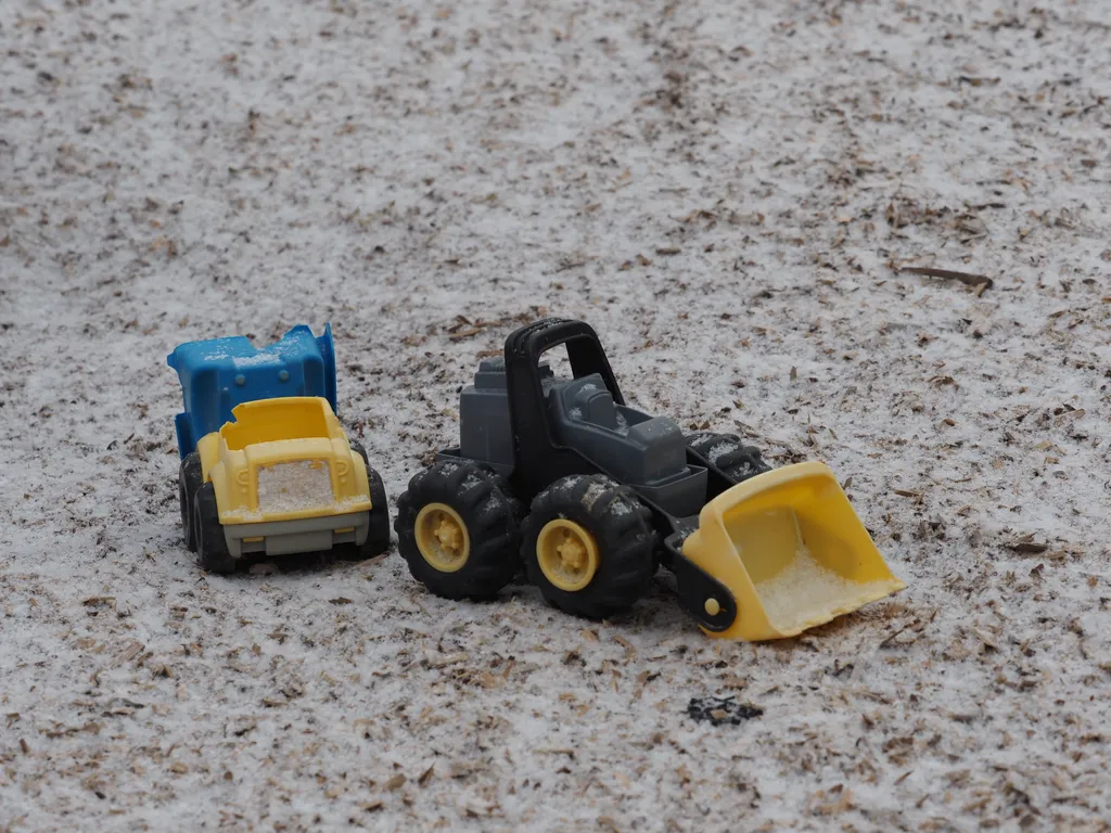 children's toy trucks in the snow