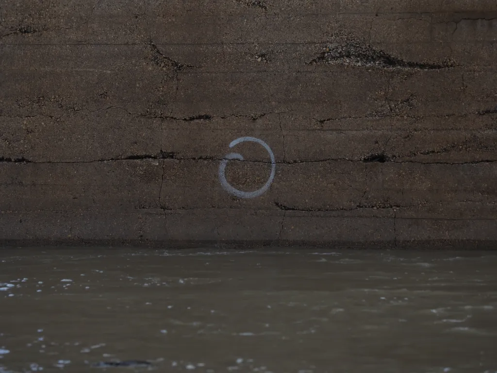 a swirl drawn onto the concrete support of a bridge