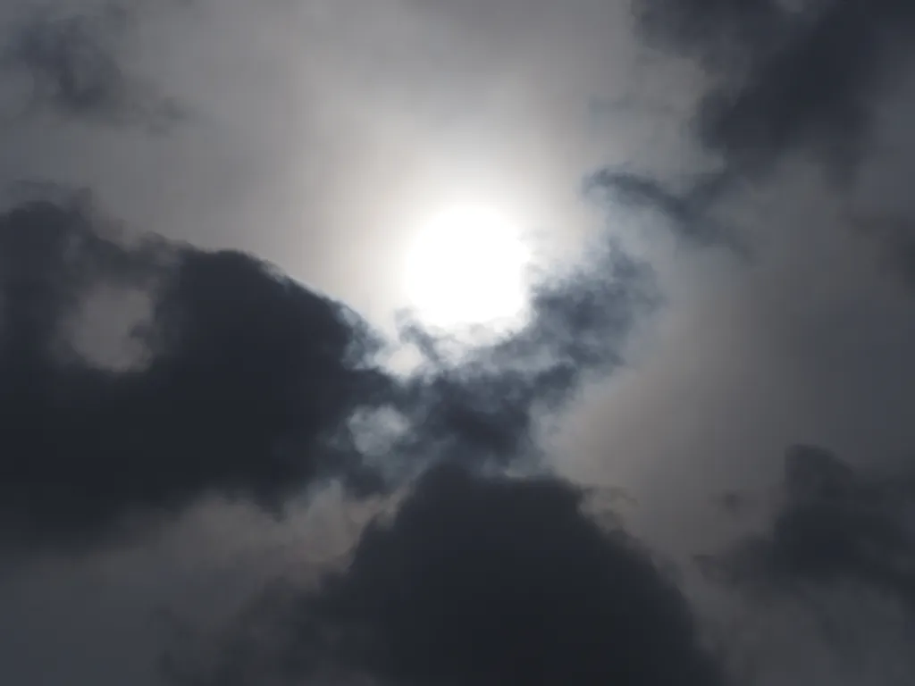 the sun behind clouds