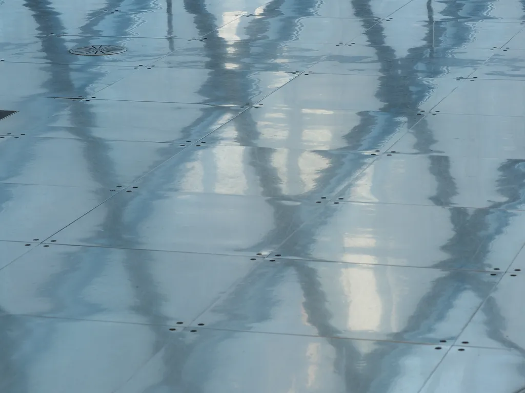 hexagonal windows viewed in a shiny metal floor