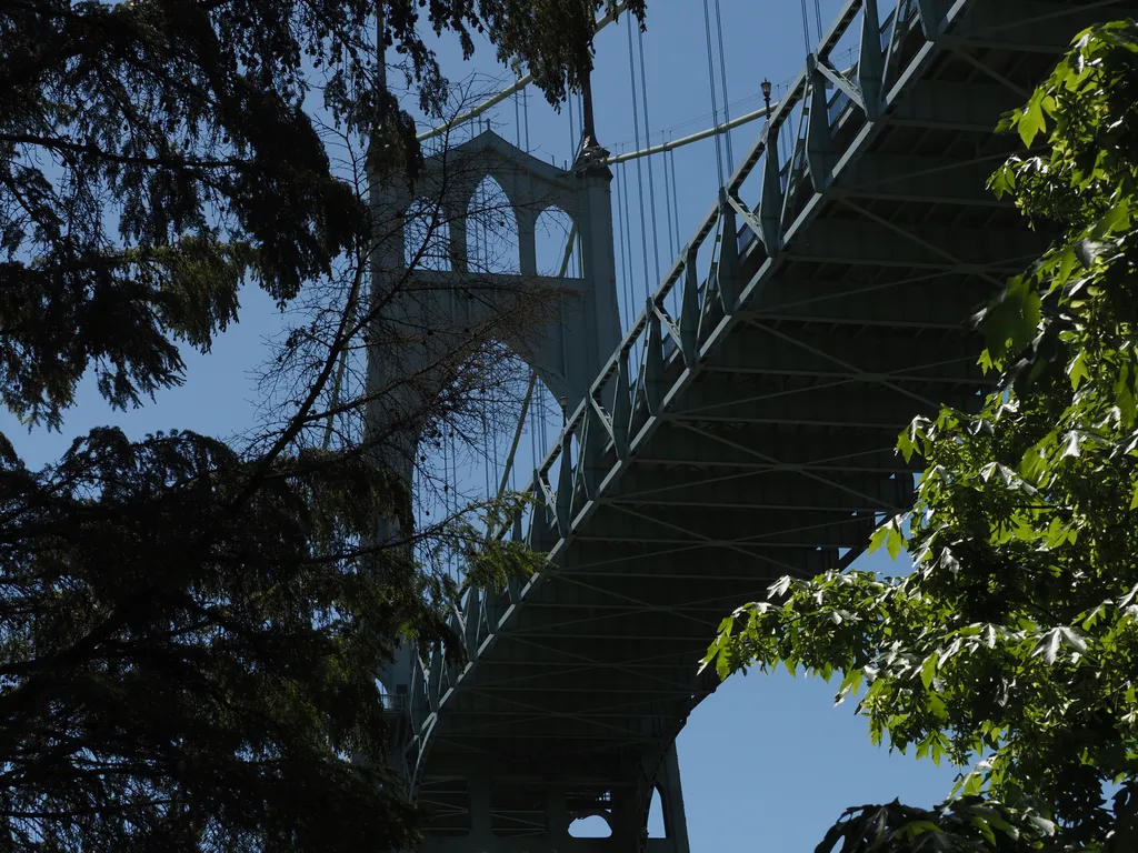 a tall green suspension bridge