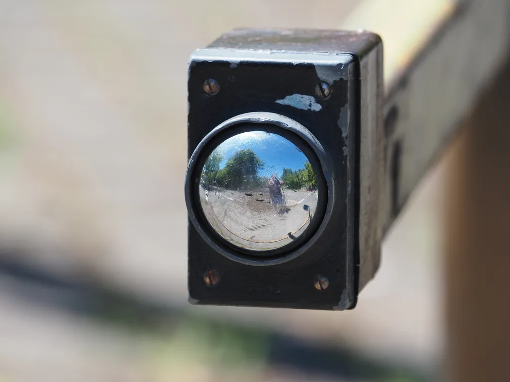 a selfie in a mirrored walk button