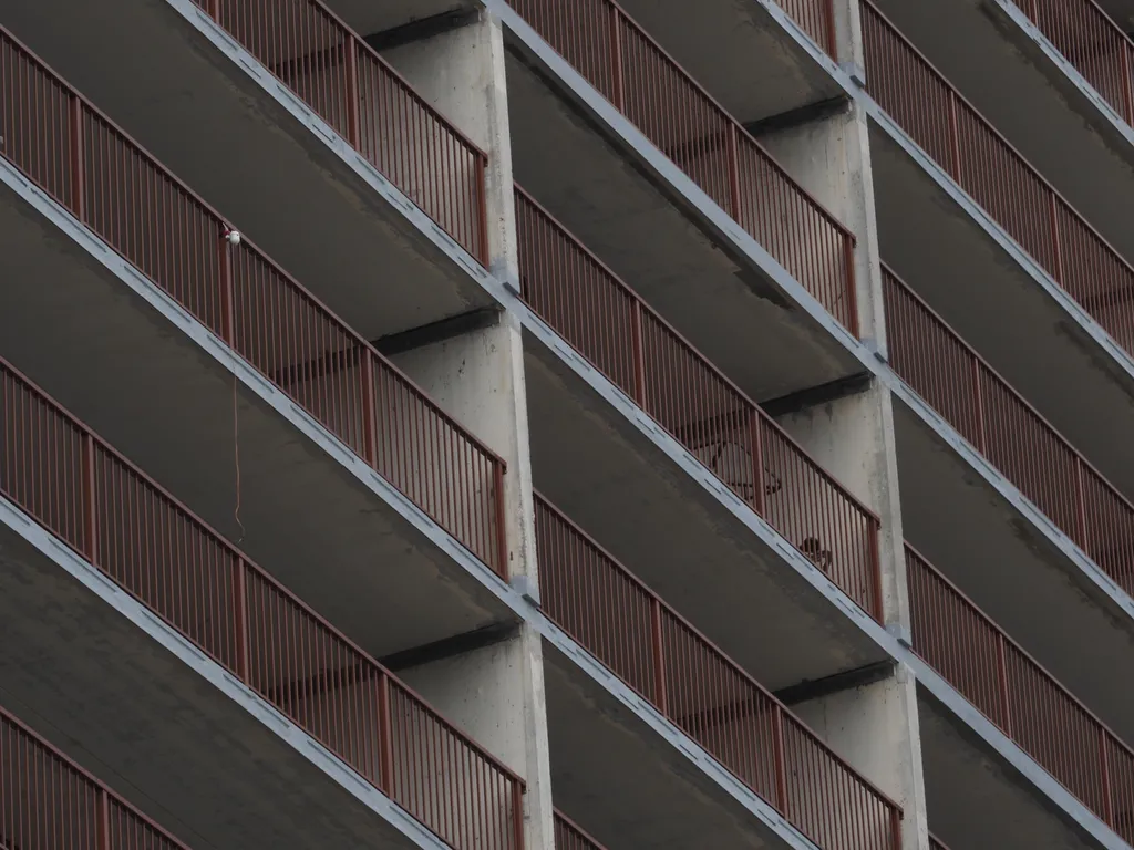 boxed in concrete balconies with metal railings