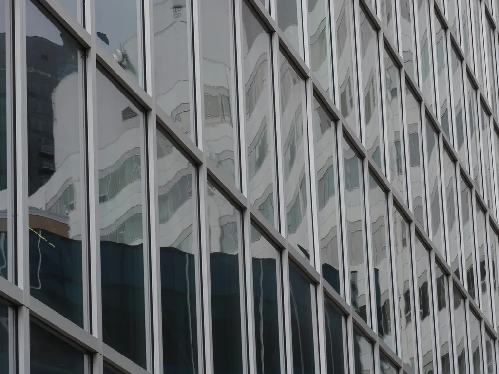 buildings reflected in glass windows