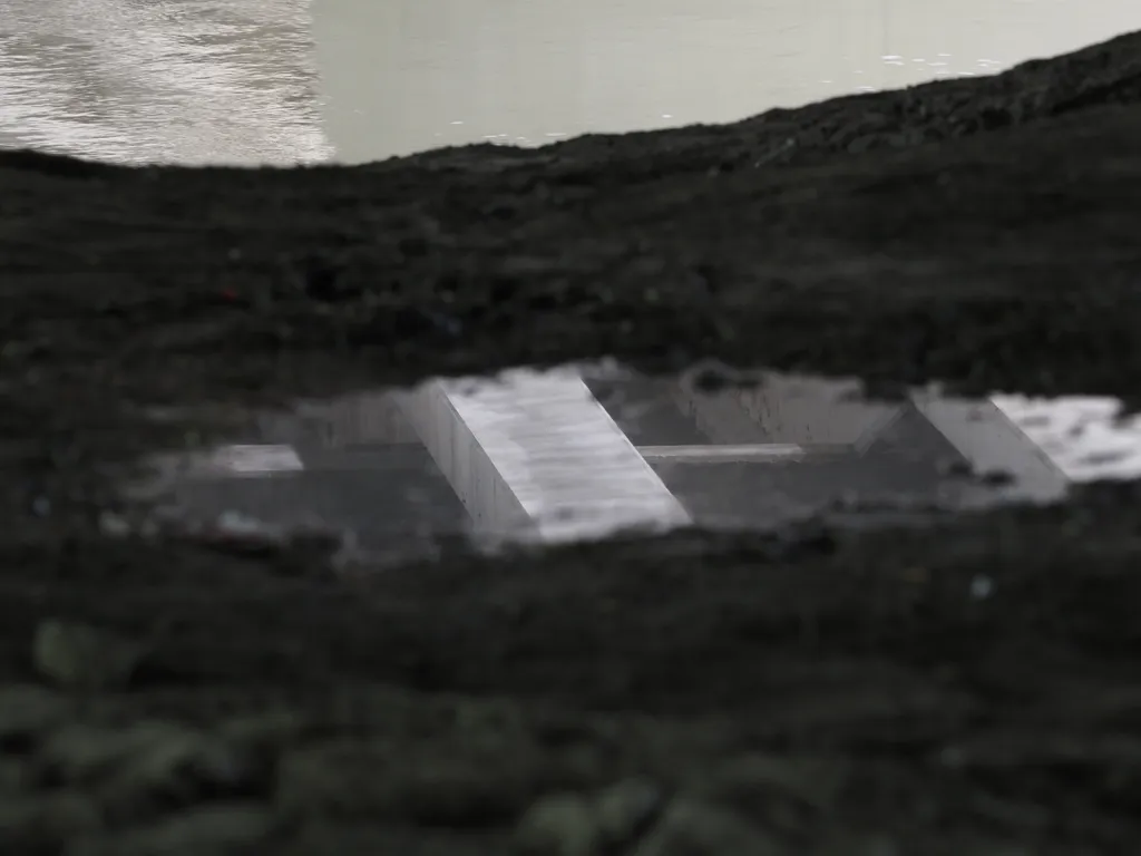 a bridge reflected in a puddle