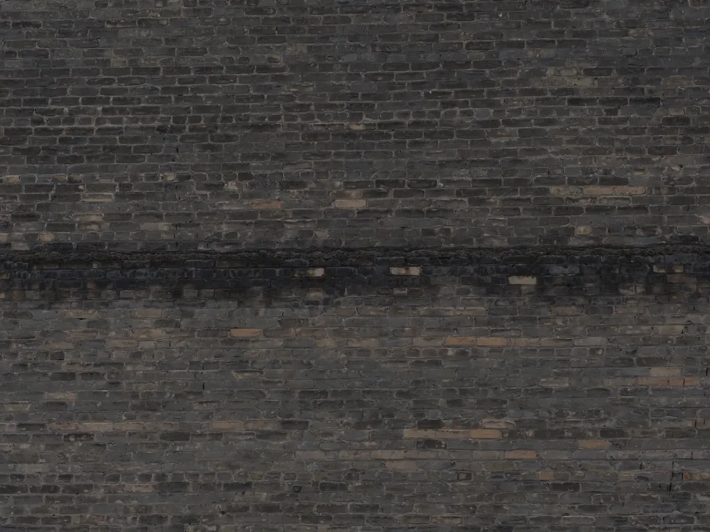 the frame of a brick building visible on the outer wall of another