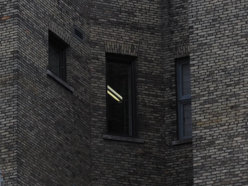 windows facing each other in an alcove in a brick building