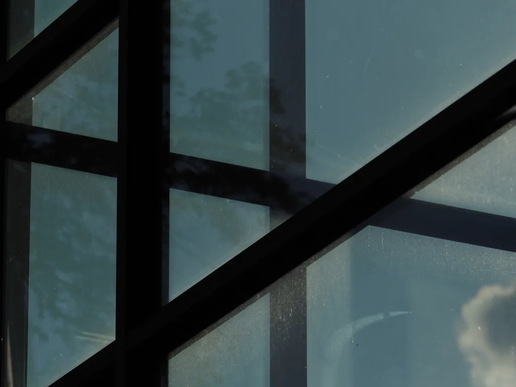 clouds visible through the windowed atrium of an apartment building