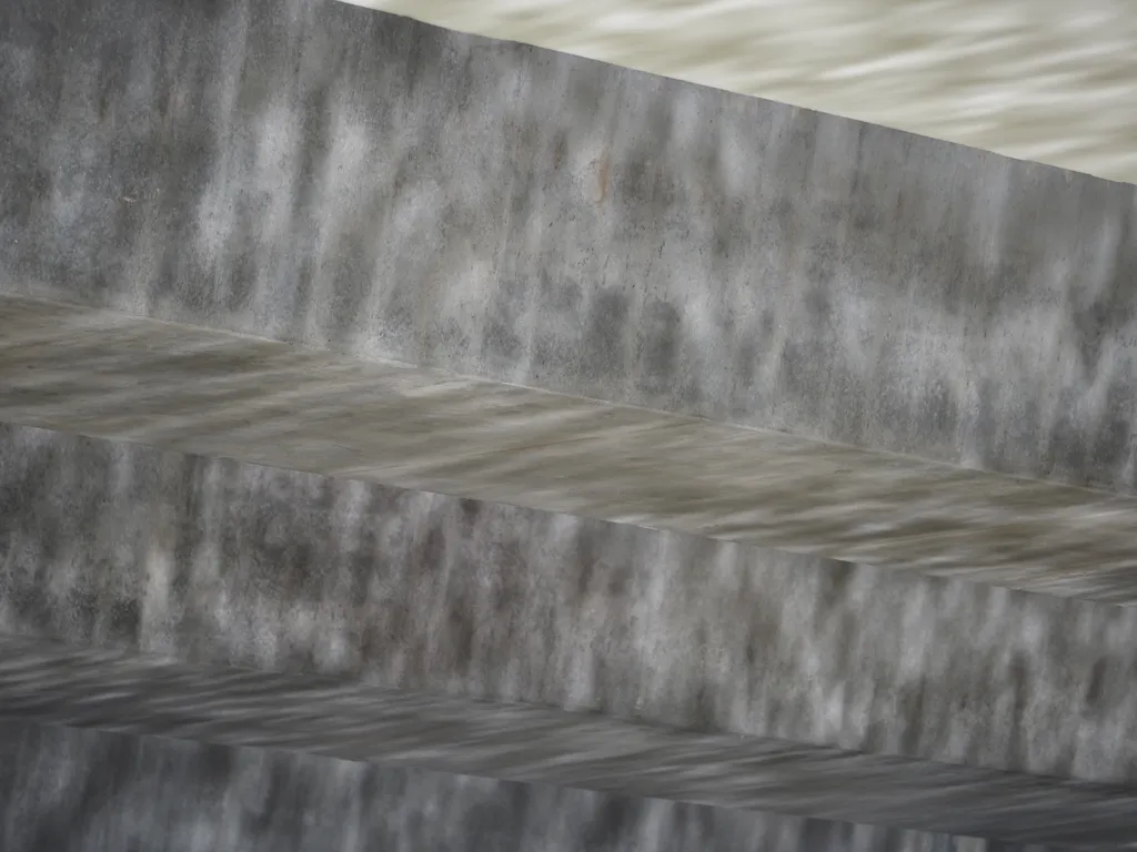 reflections in a river as seen by the shadows it casts on a bridge