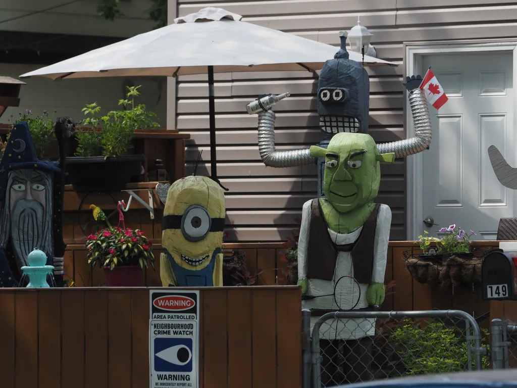 wooden sculptures of Shrek, a Minion, Bender, and a wizard