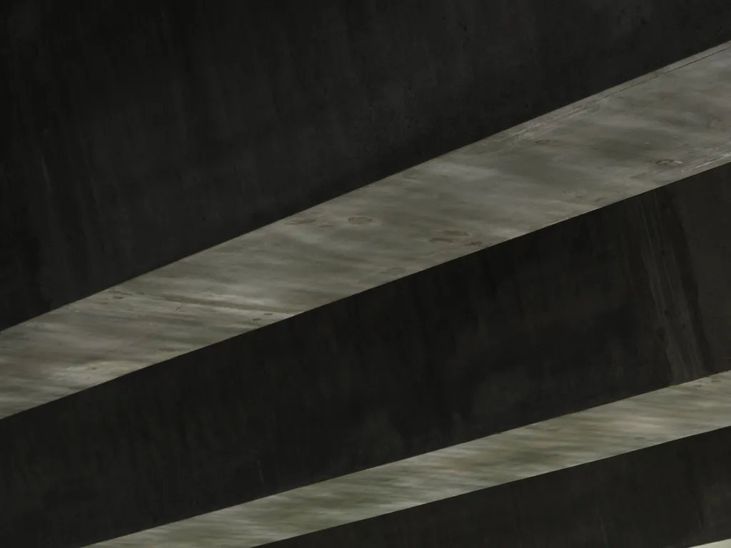 concrete beams on the underside of a bridge