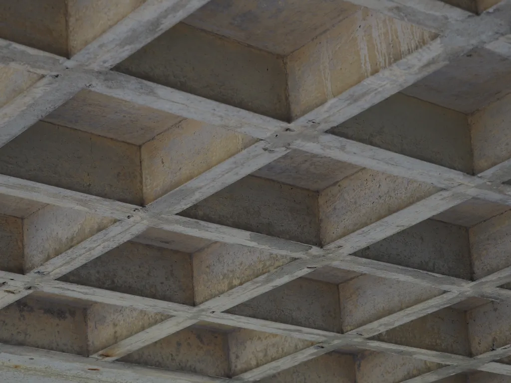 concrete squares reenforcing a portico under a building