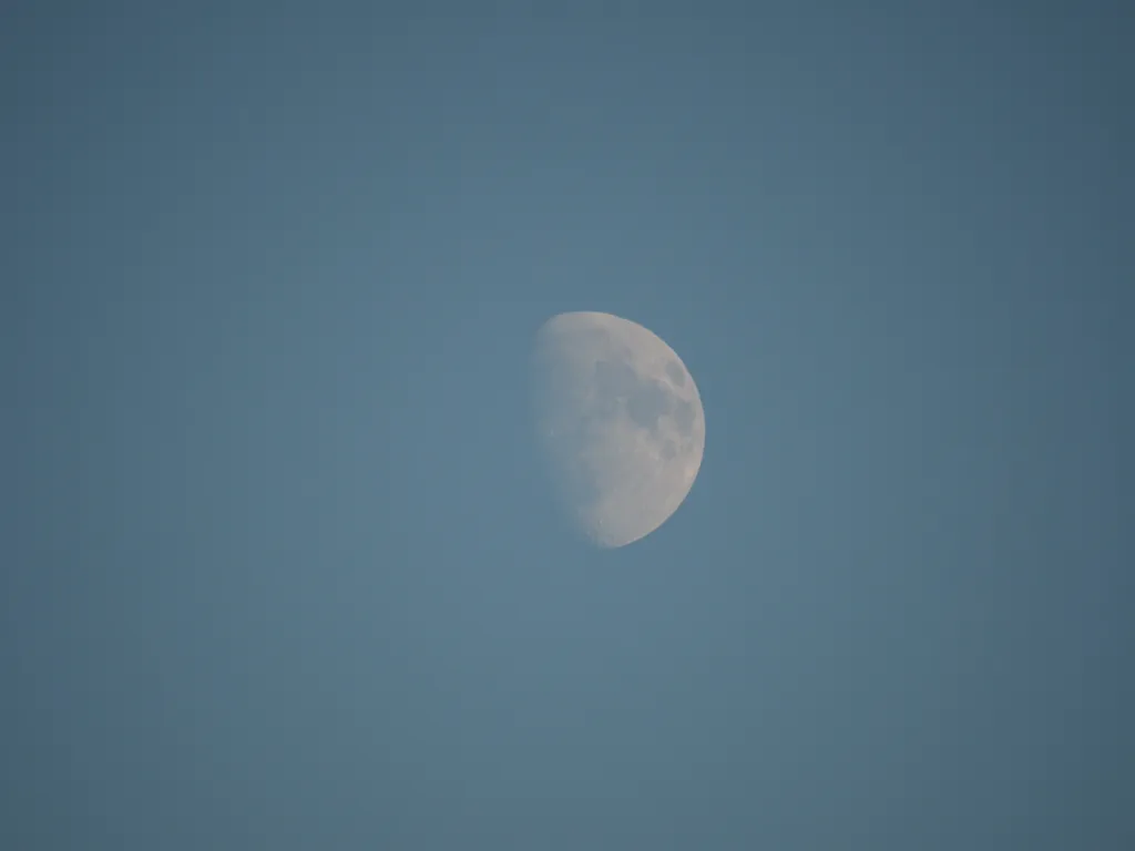 the moon against a blue sky