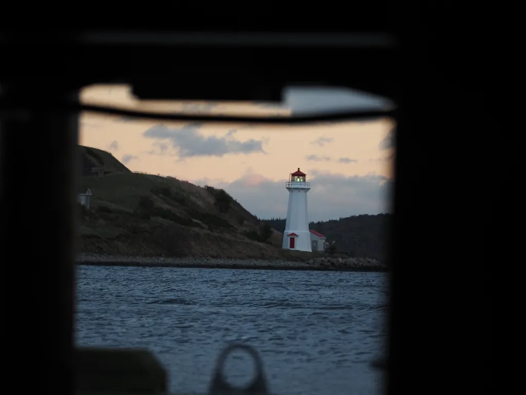 a lighthouse viewed from the underside of a pier