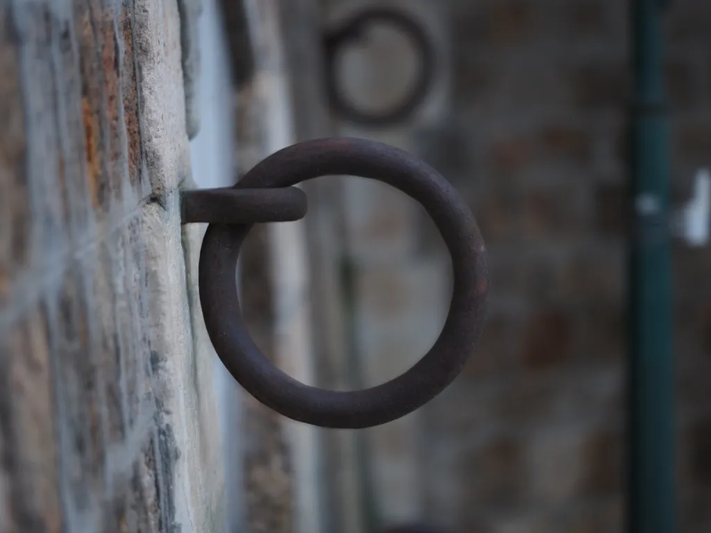 a metal mooring ring on a stone wall