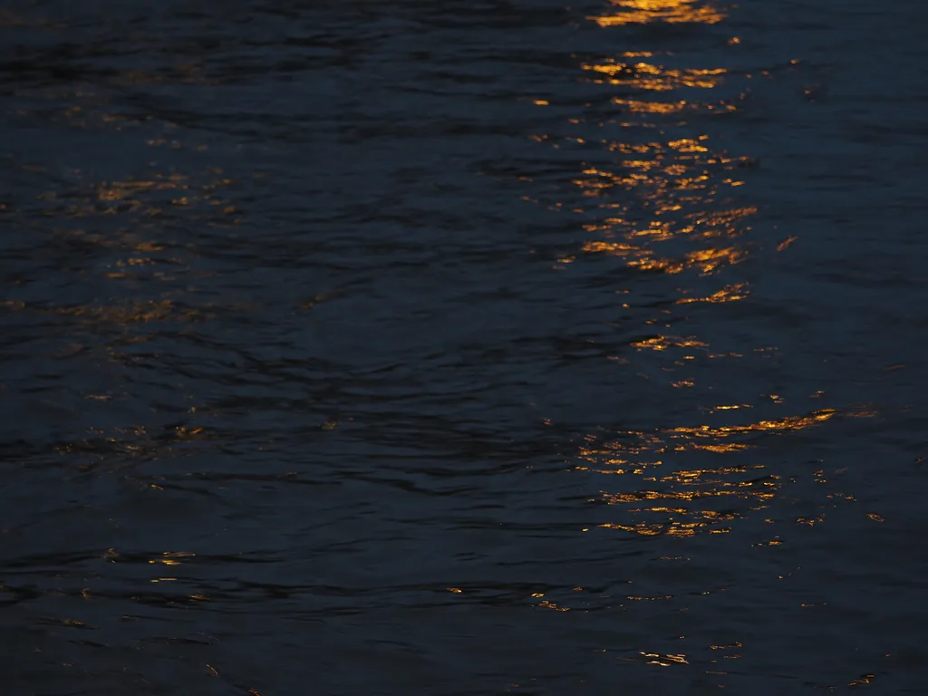 lights reflecting on a river at night