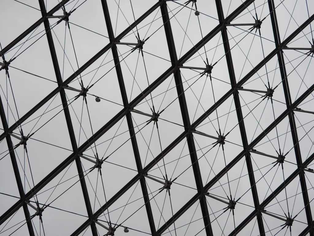 the metal lattice that supports the glass pyramid of the louvre