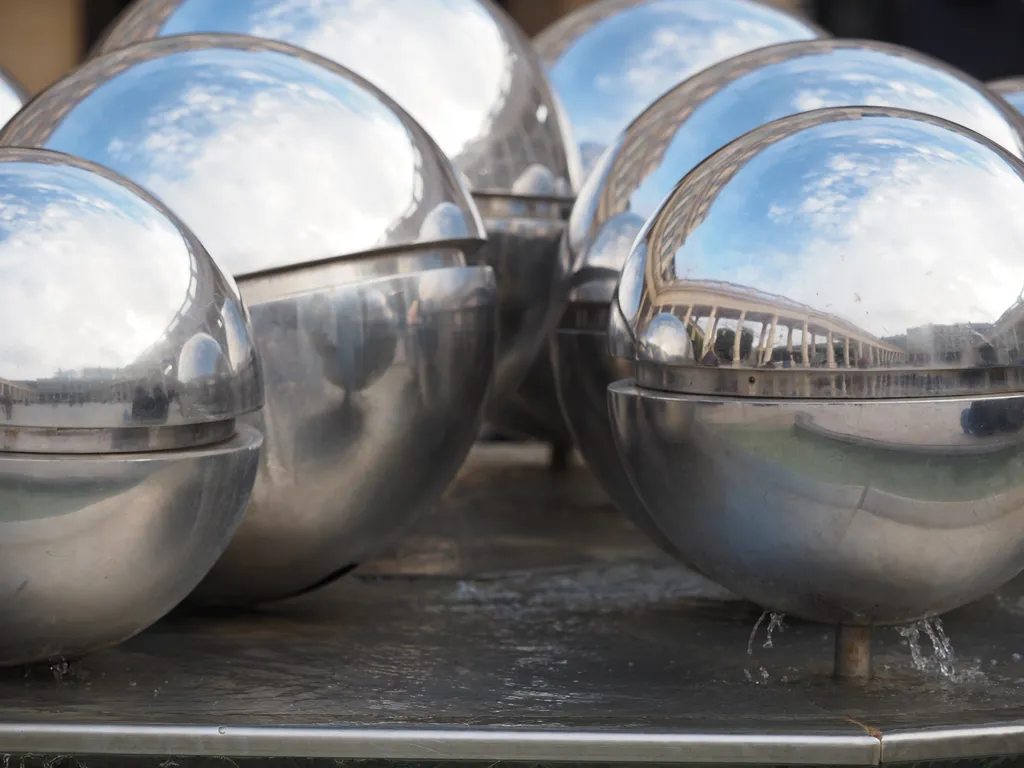 a fountain constructed of many shiny metal balls