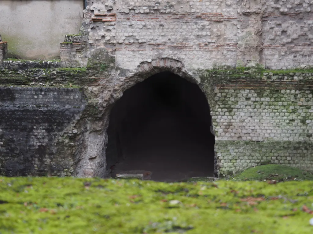 a rough arch in an old stone building