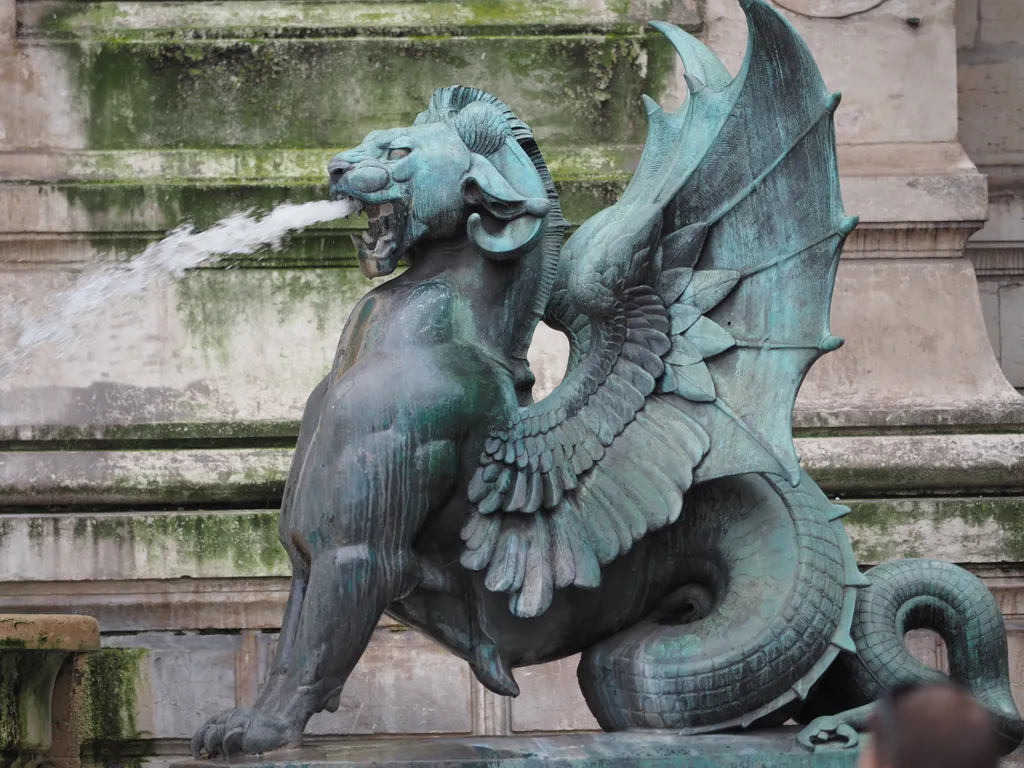 a winged lion with serpaint tail spewing water