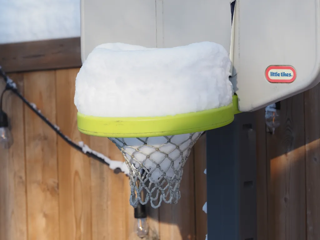 a children's basketball hoop full of snow