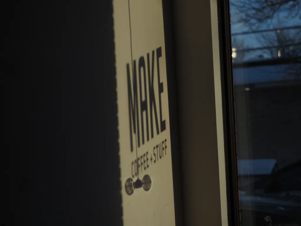 the sign from a building reflected on its wall