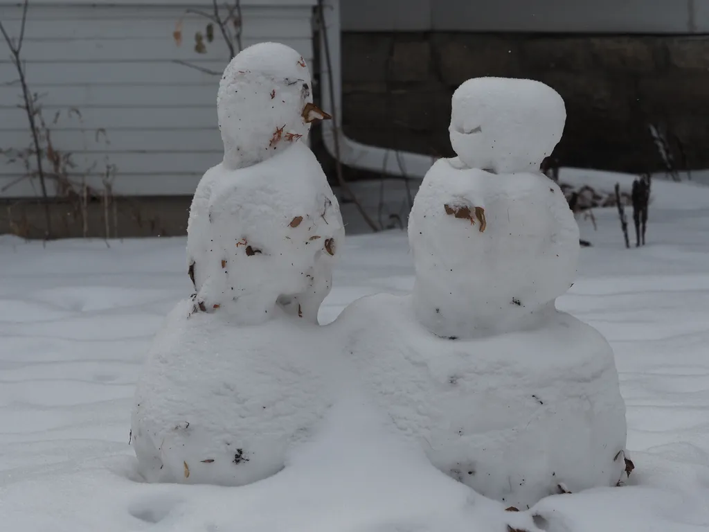 two snowmen facing each other